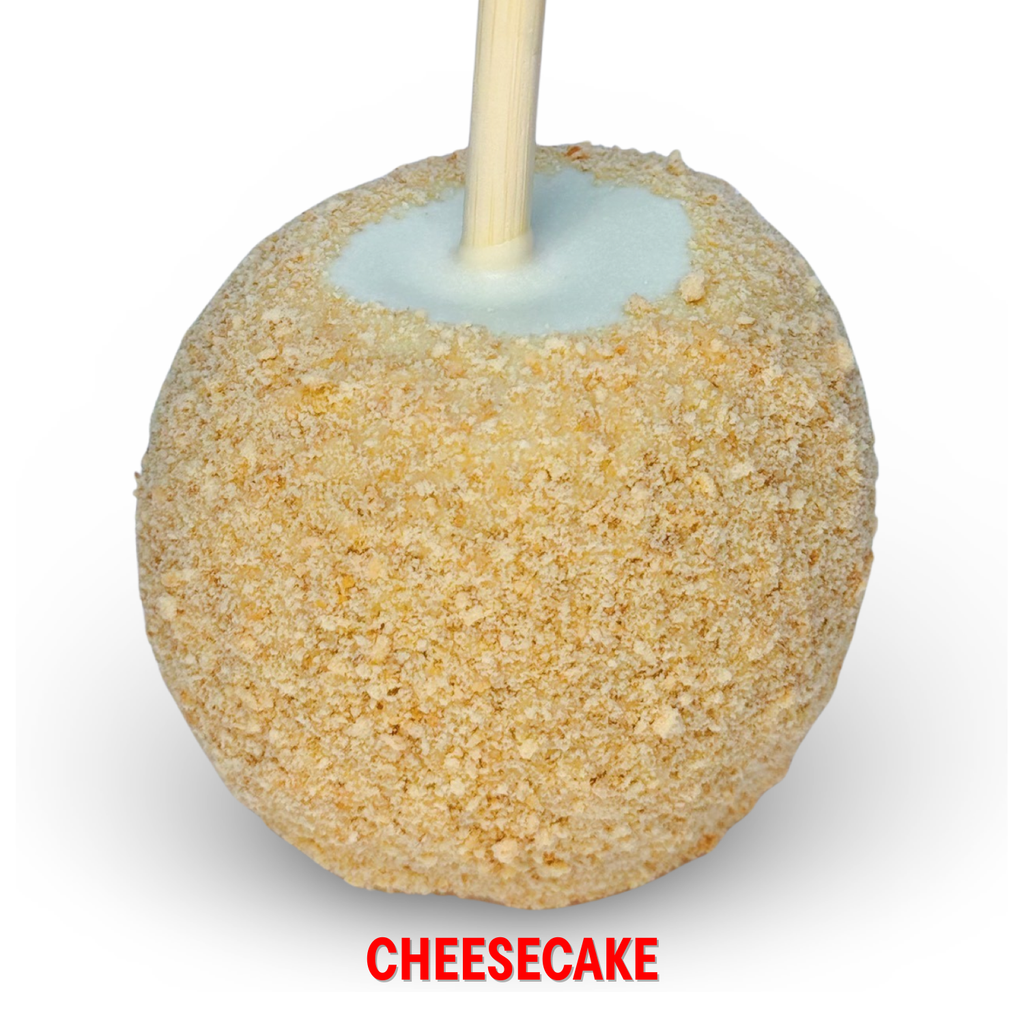 White chocolate caramel apple with graham cracker crumble topping on white background.